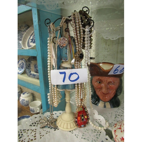 70 - Lot of costume jewellery on stand.