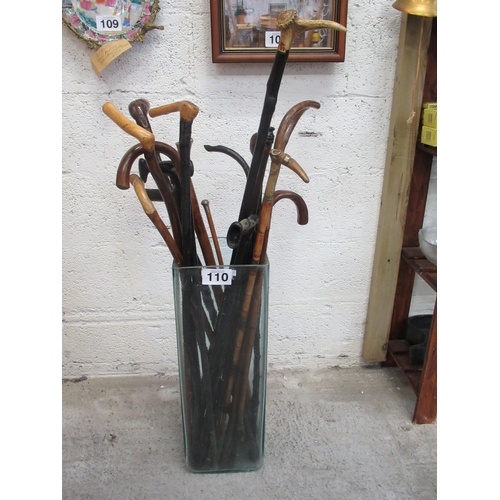 110 - Umbrella and stick stand plus 20 assorted walking sticks. Some of these are hand crafted by the late... 