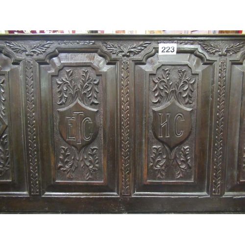 223 - Good 18th century carved paneled back settle bench on stretcher base.  H: 112cm, L:144cm, D:54cm.