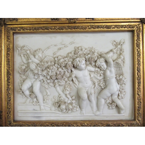 351 - Gilt framed beveled mirror depicting Cherubs.  108cm x 57cm.