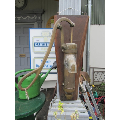 33 - Antique Brass wall mounted pump.