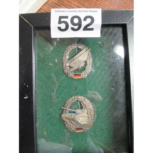 592 - Pair of tank Badges Framed.