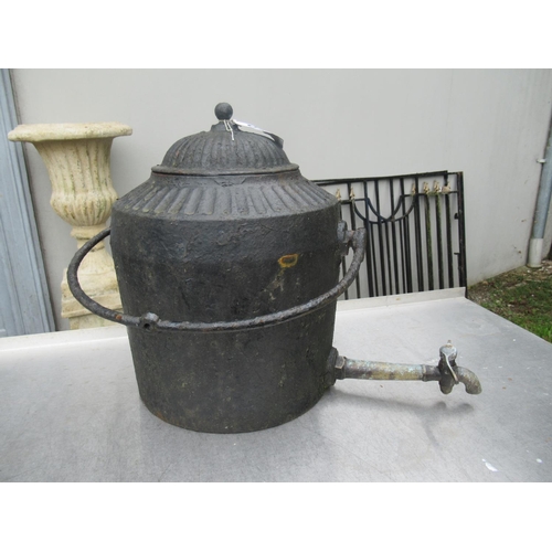 21 - Antique metal road side pot with brass tap.