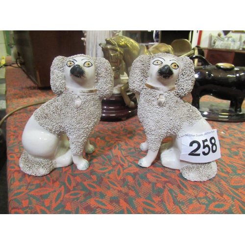 258 - Pair of Pearl Ware Staffordshire dogs.  H:15cm, W:12cm. 1 leg cracked and repaired.