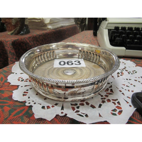 63 - Silver plate wine coaster.