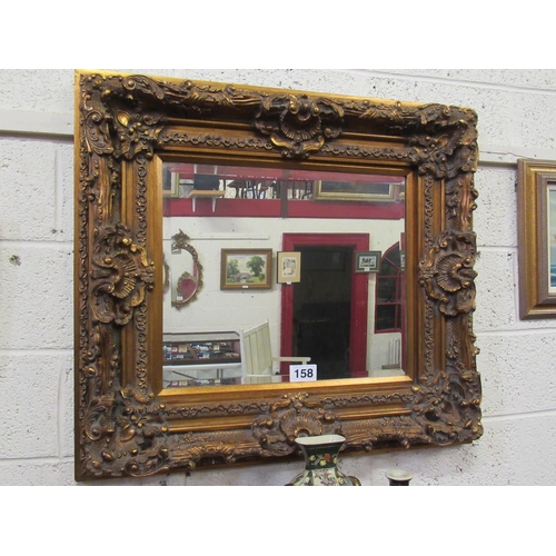 158 - Ornate Gilt framed bevelled edge wall mirror.  85cm x 96cm, D:10cm.