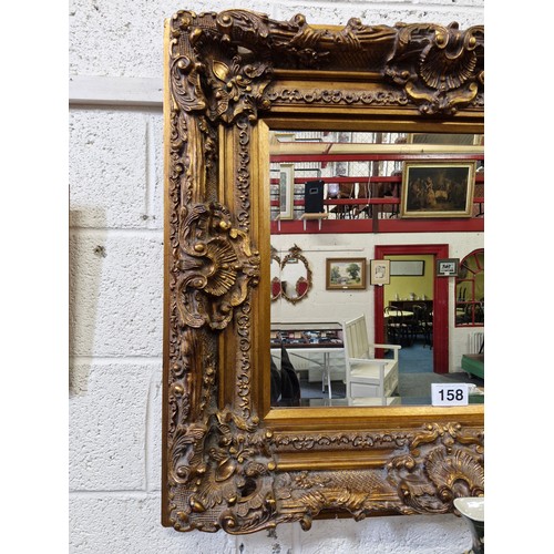 158 - Ornate Gilt framed bevelled edge wall mirror.  85cm x 96cm, D:10cm.