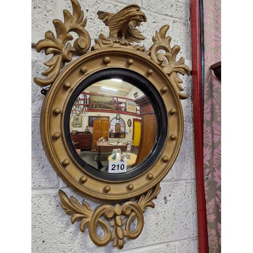 210 - Gilt frame Convex wall mirror depicting Eagle.  H:79cm x 55cm.