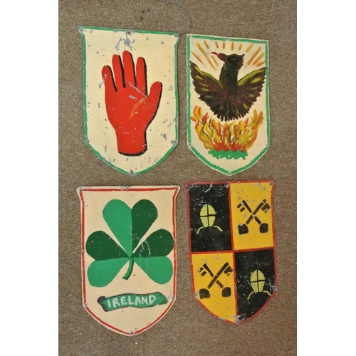 389 - A collection of 4 handmade double sided tin shields, each side with hand painted design. Each shield... 