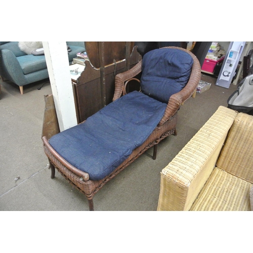 421 - A rattan chaise lounge.