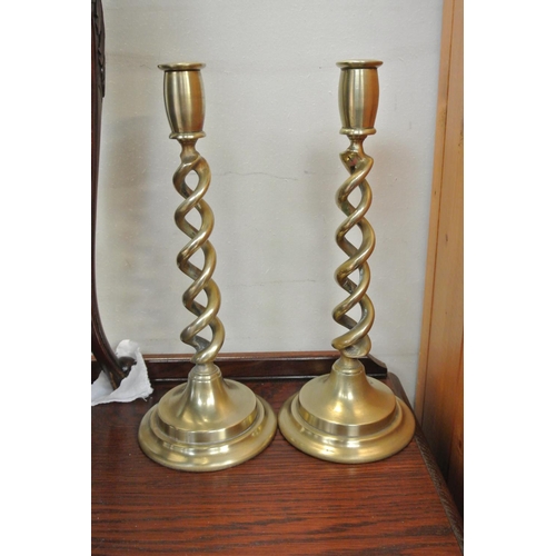 90 - A pair of decorative brass candlesticks.