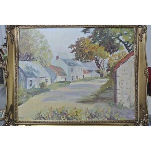 128 - An original framed oil on board painting of a village scene.

Titled 'Red Bay Village'.

Measures 59... 