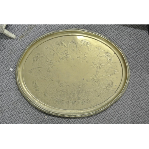 101 - A large antique brass oval tray with decorative design.