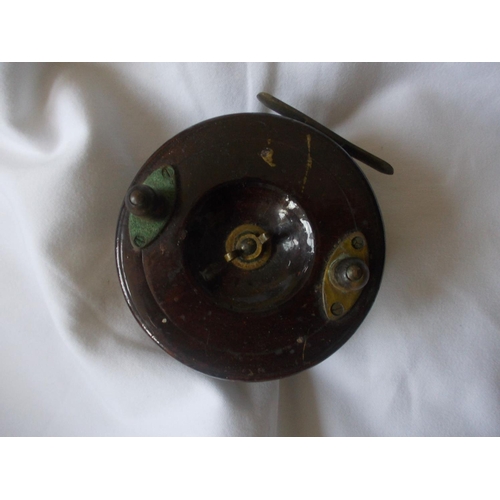 221 - An antique fishing reel, dark wood with brass fittings