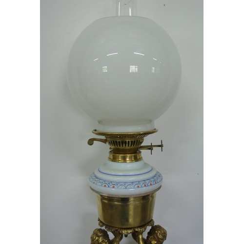 405 - A stunning antique oil lamp with brass cherub base.