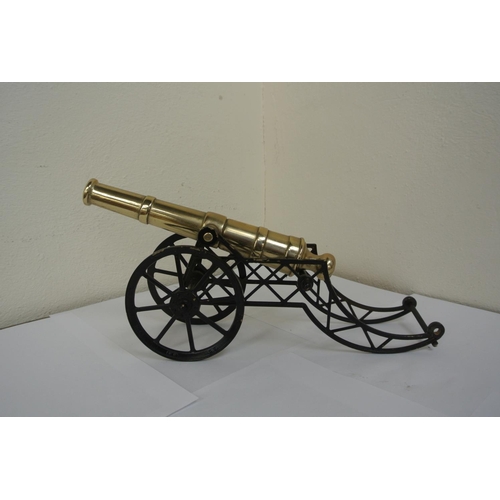 78 - A brass model canon, measuring 26cm, with stand.