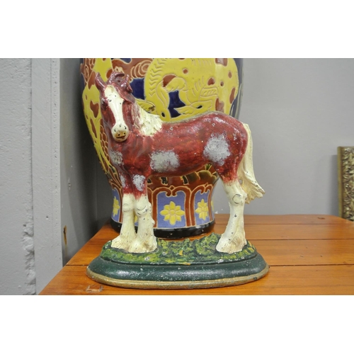 135 - A cast iron door stop showing a horse