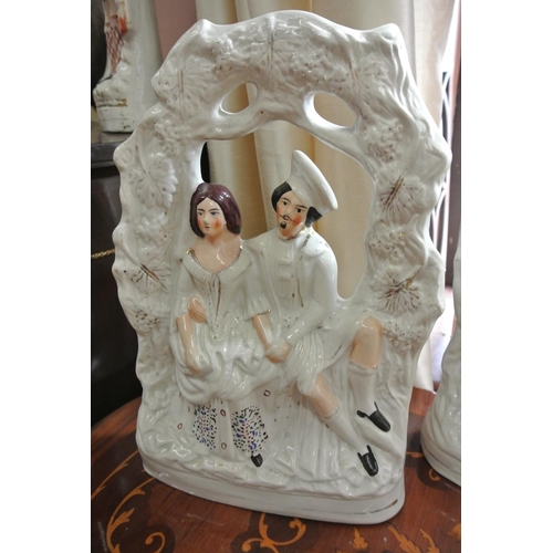 170 - An antique Staffordshire figure of lovers under an archway.