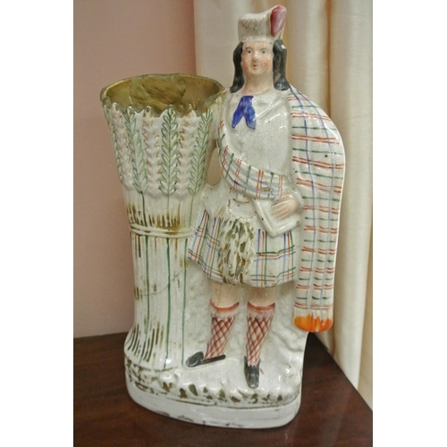 171 - An antique Staffordshire spill vase modelled as a Scottish Soldier.