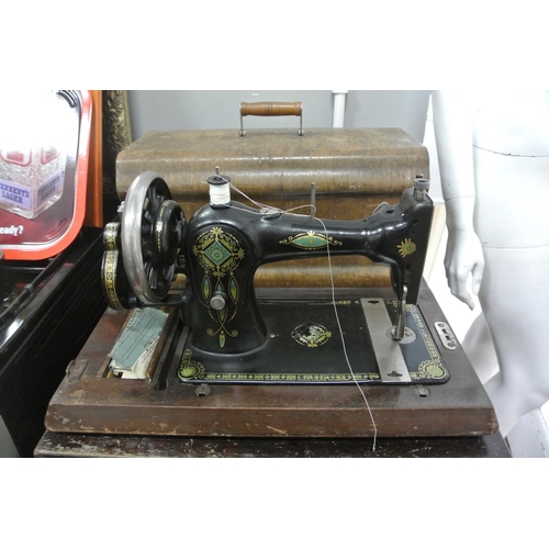 193 - A vintage wood cased sewing machine.