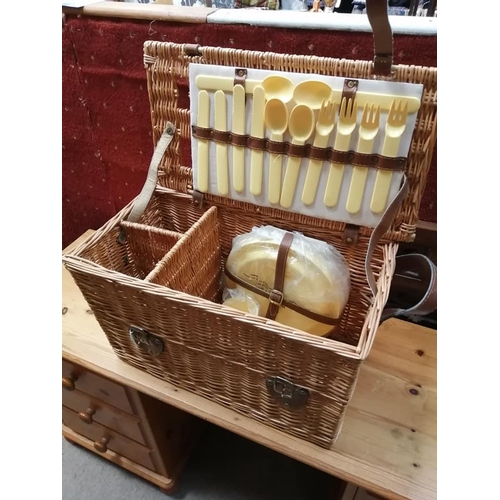 202 - A vintage wicker picnic hamper with contents.