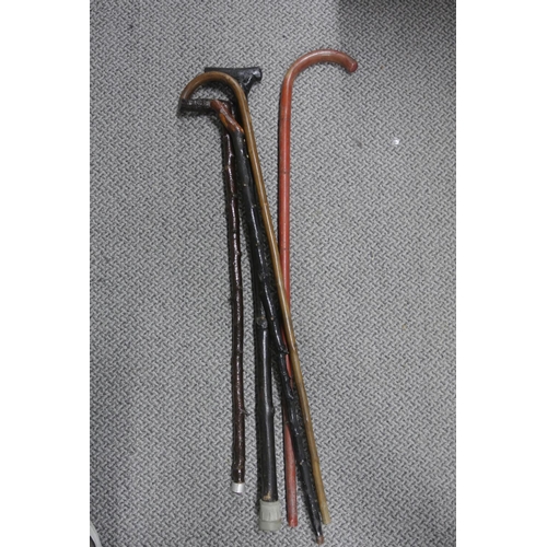 214 - A collection of 5 walking sticks, including a blackthorn stick.