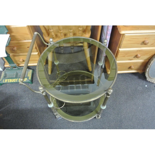 230 - A vintage/ retro circular brass & glass drinks trolley.