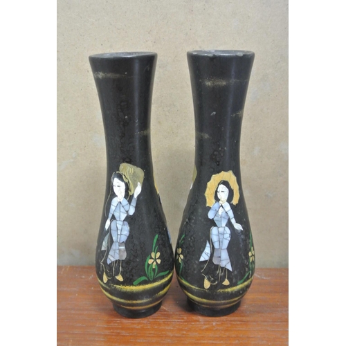 246 - A pair of unusual vases with Oriental design, each measuring 21cm tall.