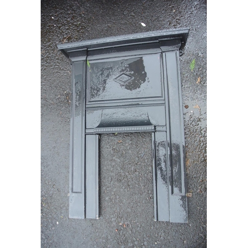 326 - An antique cast iron fireplace.