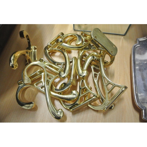 65 - A large collection of brass door hangers