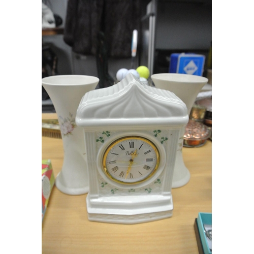 85 - An assortment of ceramics which includes a Belleek clock and more