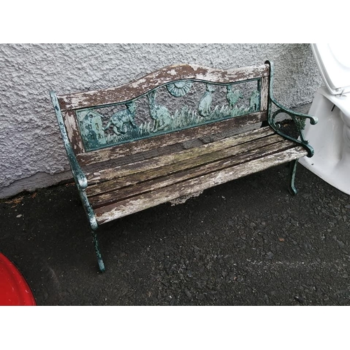 322 - A small garden bench with cast iron ends & back panel.