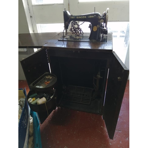 192 - An antique Singer cabinet sewing machine.