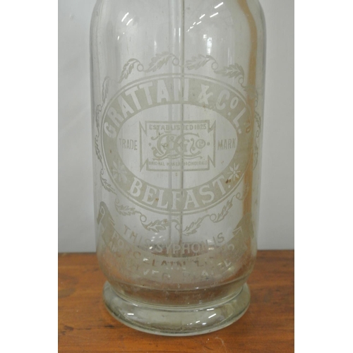 165 - An antique/ vintage glass soda syphon, reading 'Grattan & Co LTd - Belfast'.