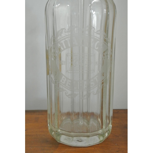 166 - An antique/ vintage glass soda syphon, reading 'Grattan & Co LTd - Belfast'.