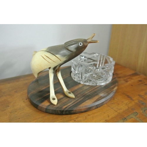 172 - A vintage novelty ashtray, with carved horn modelled as a bird mounted on wooden base with glass dis... 