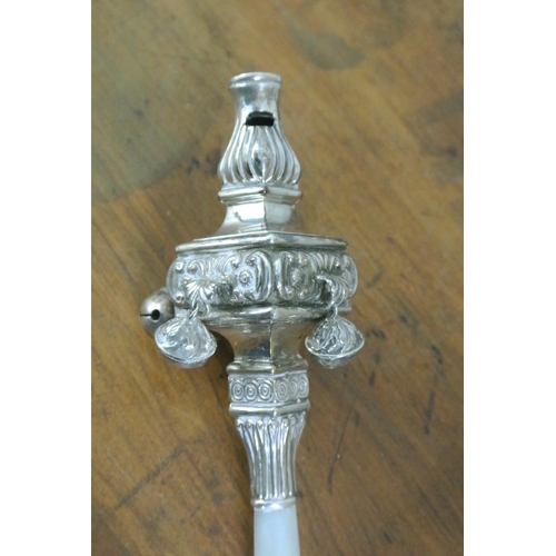 177 - An antique sterling silver baby's rattle/ whistle, with mother of pearl handle.