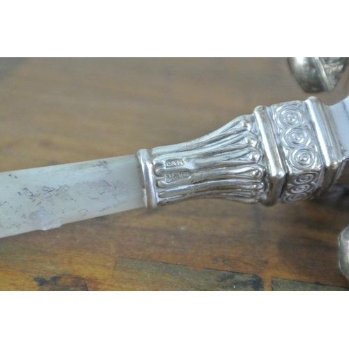 177 - An antique sterling silver baby's rattle/ whistle, with mother of pearl handle.