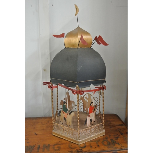 200 - A tin plate model merry go round/ hobby horse.