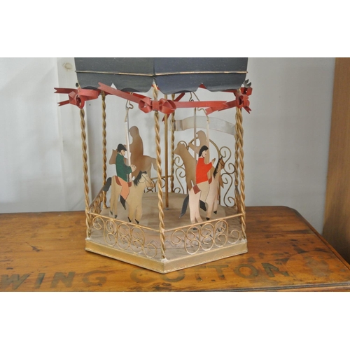 200 - A tin plate model merry go round/ hobby horse.