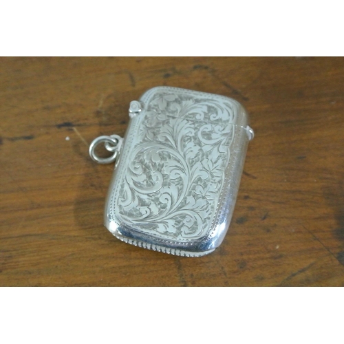 220 - An antique sterling silver vesta case with decorative design & engraved initial 'A'.