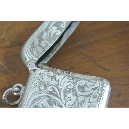 220 - An antique sterling silver vesta case with decorative design & engraved initial 'A'.