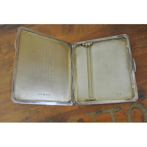 260 - An antique sterling silver cigarette case with engine turned design, engraved to interior 'Presented... 