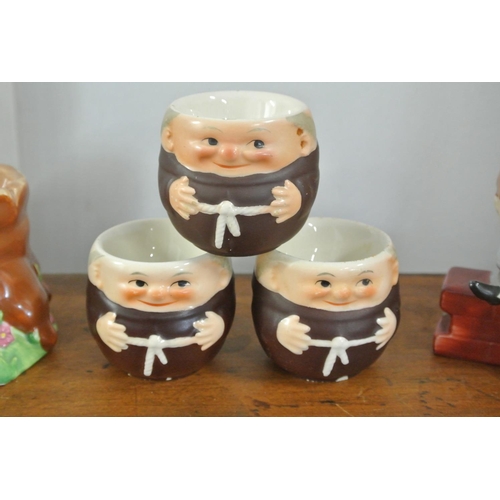 272 - A collection of 5 decorative egg cups, to include a Disney Piglet piece, 3 Goebel Hummel Monks & a H... 