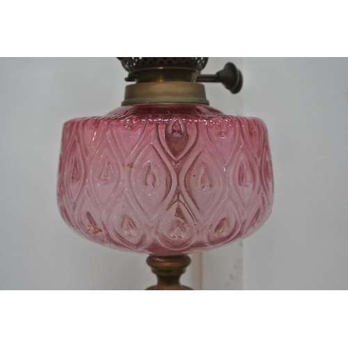 310 - An antique oil lamp with decorative glass reservoir & etched coloured glass shade.