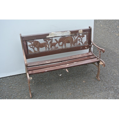 353 - A small child's garden bench with cast iron ends & back panel.