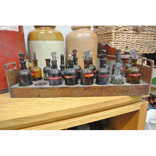 374 - An assortment of various bottles on 2 wooden racks.