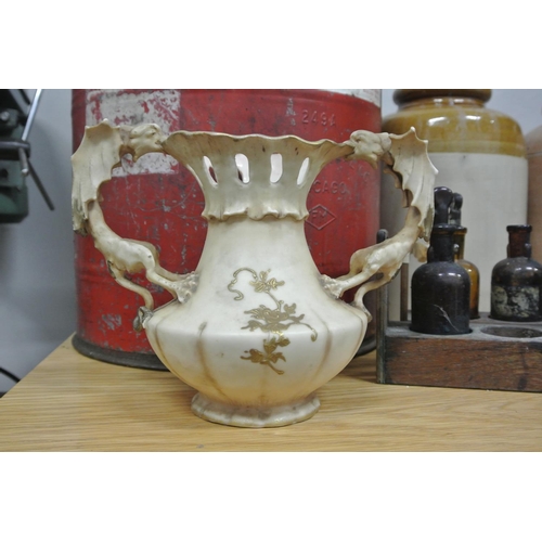 377 - An unusual Royal Worcester style vase with dragon handles & decorative design.