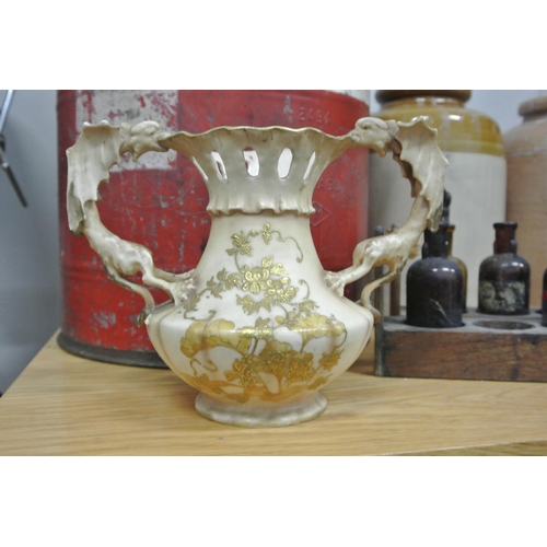 377 - An unusual Royal Worcester style vase with dragon handles & decorative design.