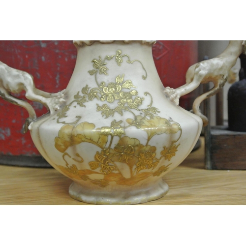 377 - An unusual Royal Worcester style vase with dragon handles & decorative design.